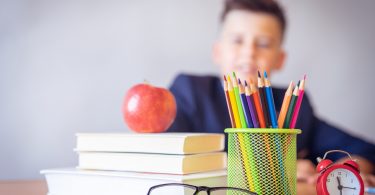 school kid books apple pencils