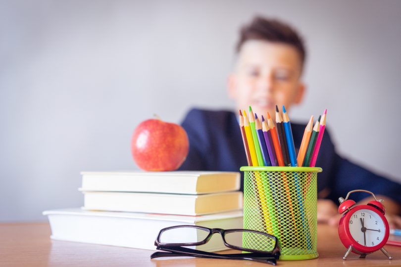 school kid books apple pencils
